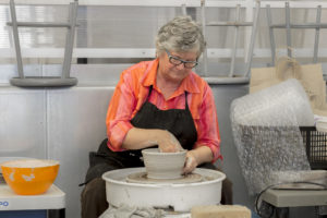 woman working at a pottery wheel
